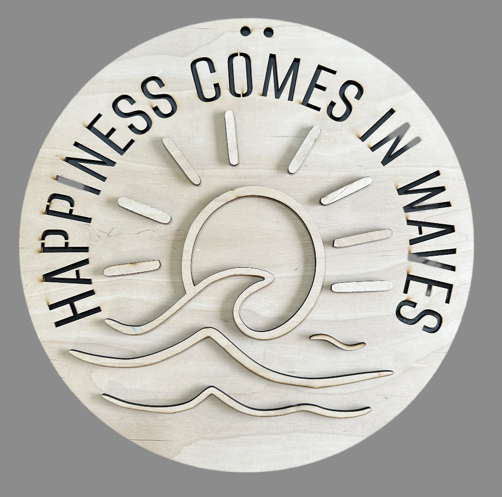 A circular wooden plaque with the text 'Happiness comes in waves' carved on it, alongside a graphic of a sun and sea.