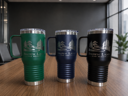Three insulated travel mugs with 'Brown Land and Realty' branding on a wooden surface.