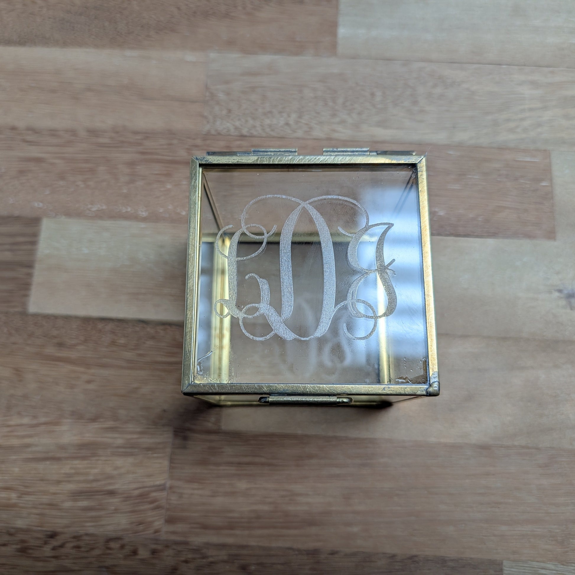 Decorative glass box with engraved design on a glass surface