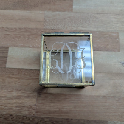 Decorative glass box with engraved design on a glass surface